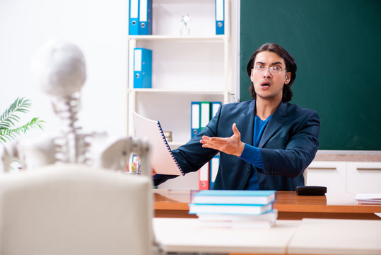 Male teacher and skeleton student in the classroom 