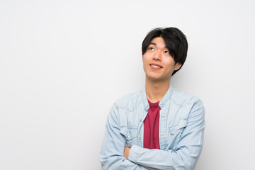Fototapeta premium Asian man on isolated white background looking up while smiling