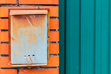 A beautiful mailbox hangs waiting for newspapers, parcels and letters.