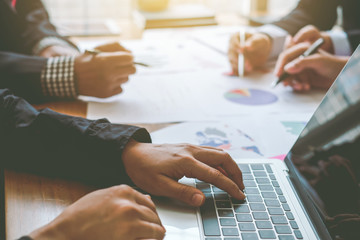 Business people meeting together about investment and the discussion graph financial information at...