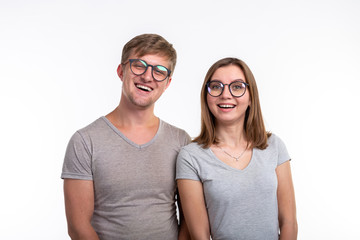 People and education concept - Two young funny student with thoughtful faces over white background