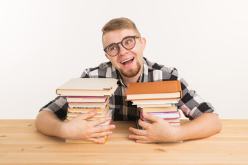 People, knowledge and education concept - Happy funny student dressed in plaid shirt sitting at the...
