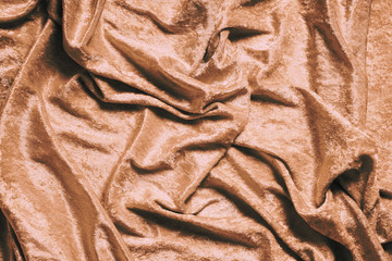 gold or copper colored luxury panne velvet drape background texture