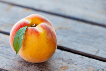 Fresh peaches on grey wooden background. Close up. Copy space.
