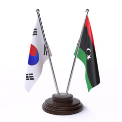 South Korea and Libya, two table flags isolated on white background. 3d image