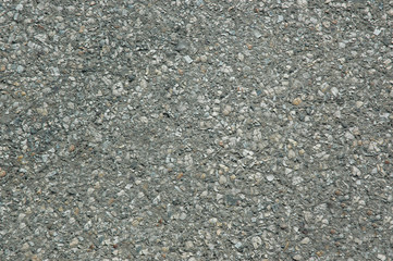 Asphalt roadway with a rough grey surface .Texture or background.
