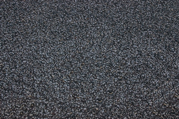 Asphalt roadway with a rough dark surface .Texture or background.