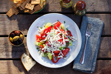 Vegetable Bulgarian shopska salad. Wooden background. Top view.