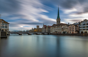 Fototapeta na wymiar Kirche Fraumünster in Zürich, Switzerland. Panoramic Long exposure view of the historic city center of Zurich with famous Fraumunster Church from the river Limmat , Zurich, Switzerland.