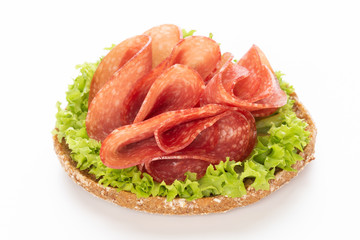 Sandwich with salami sausage on white background.