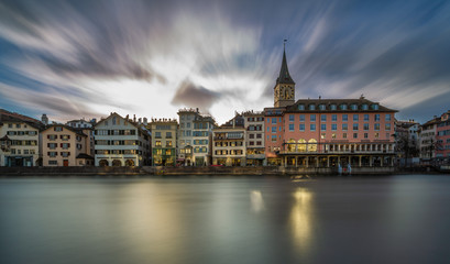 Fototapeta na wymiar Limmat River at Sunset in Zürich, Switzerland. Panoramic long exposure of the view of historic Zurich city center and river Limmat , Switzerland Europe