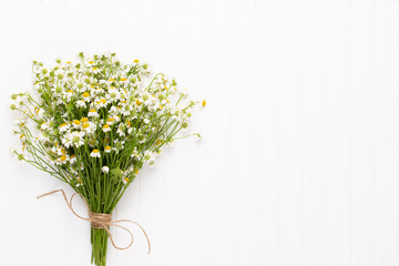 Chamomile flowers floral framee. Flat lay, top view.