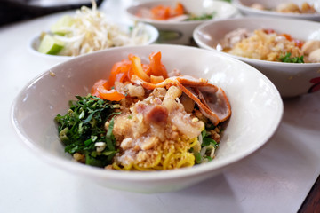 Thai dry noodle tom yum (Kuay Tiew Thai) with minced pork, red pork, pork ball.