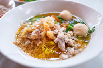 Thai noodle soup tom yum (Kuay Tiew Thai) with minced pork, red pork, pork ball.