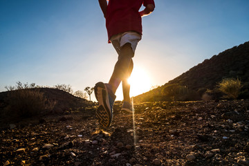 teenager running alone at the mountain with sunset - man jogging - positive vibes - 
