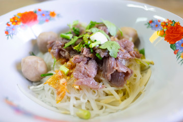 Dry noodle with rice stick noodles, parsley, garlic oil, meatball and scalded beef.