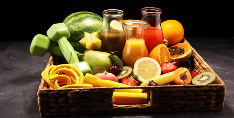 Healthy lifestyle concept. healthy fruits, smoothies and sport fitness equipment, dumbbells and jumping rope