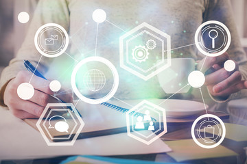 Social network theme hologram over hands taking notes background. Concept of global international people connect. Double exposure