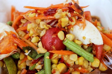  Spicy vegetable salad mixed with salted eggs and corn, papaya salad, fruit