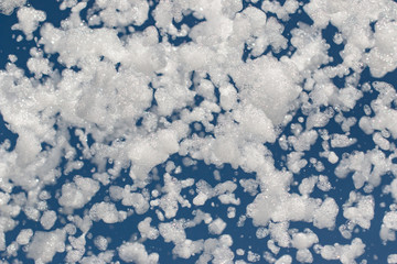 Fototapeta na wymiar white foam on a blue background