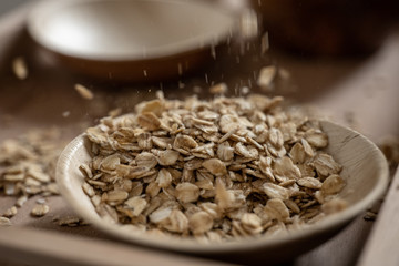 Explosion of oat flakes in a bowl