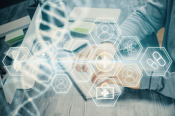 DNA hologram with businessman working on computer on background. Concept of bioengineering. Double...