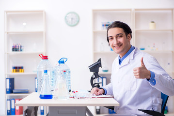Young male chemist experimenting in lab