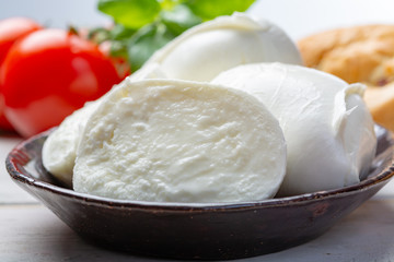 Balls and pieces of buffalo mozzarella, soft Italian scheese made from the milk of Italian Mediterranean buffalo