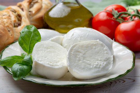 Balls and pieces of buffalo mozzarella, soft Italian scheese made from the milk of Italian Mediterranean buffalo