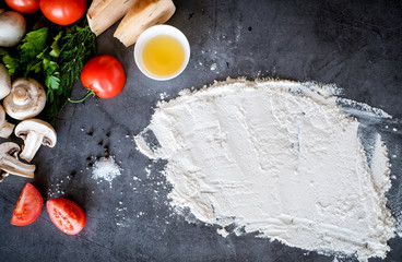 Food ingredients for pizza at black background as tomatoes,cheeze,mushrooms etc
