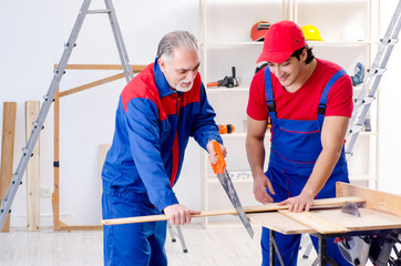 Two professional contractors laying flooring at home  