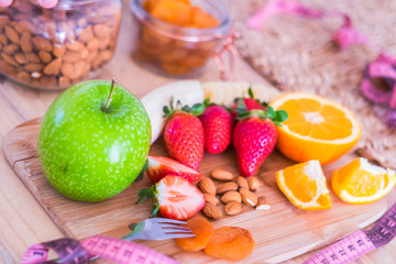 beautiful table full of food like fruits to have a good and nice breakfast at home to lose weight and stay better with yourself - in the table there are banana, framberry, orange, apple and more