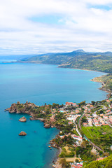 Fototapeta na wymiar Amazing view of a bay surrounding the coastal Sicilian village Cefalu from above with the hilly landscape in the background. The beautiful city is a popular Italian holiday destination