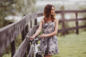 young woman in a hat riding a bicycle in a park. Active people. Outdoors