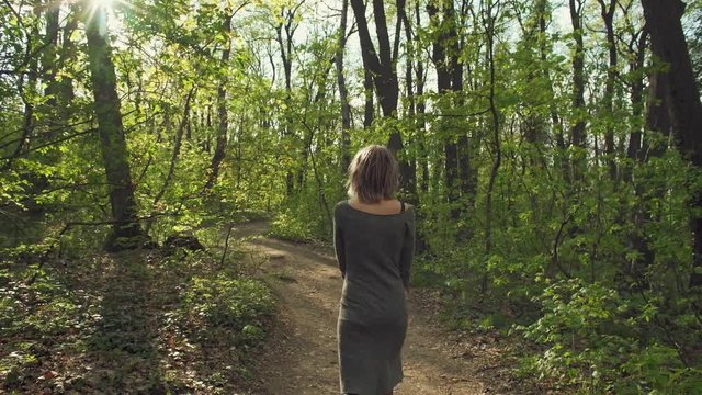 Attractive girl walks through the forest and enjoys in National Park Fruska Gora