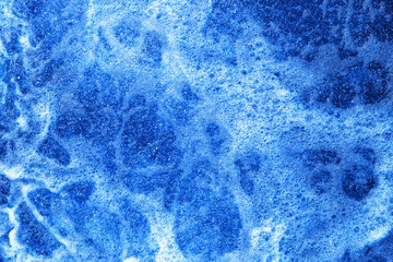 Water foam texture. Blue bubble spa washing background. Rough river water on a dam backdrop.