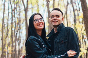 Fototapeta premium portrait of a young woman and a man walking in the autumn forest