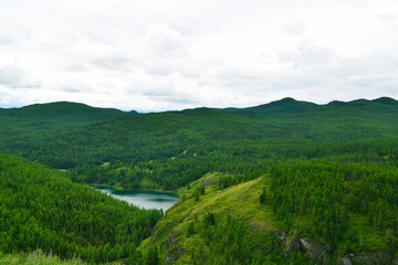 Top view on green hills and the lake.