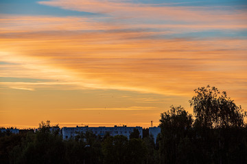Fototapeta premium dramatic red sunset colors in the sky above trees and fields