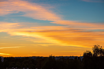 Fototapeta premium dramatic red sunset colors in the sky above trees and fields