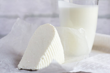 fresh soft Adyghe cheese and kefir on the table, useful dairy products for healthy eating