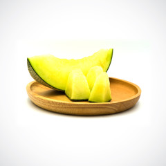 Cantaloupe Melon, In a wooden plate with green flesh on the White Blackground.