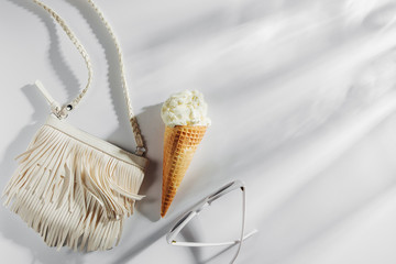 Small white bag with fringe and ice cream. Summer Vacation concept.