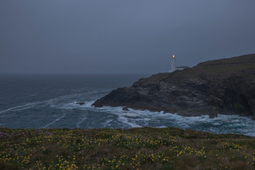 Lighthouse by the ocean on a gloomy evening on Cornwalls North coast, uk