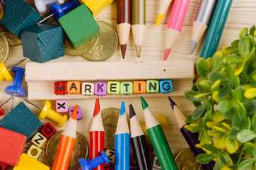 Business Campaign Concept background, colorful cube with word MARKETING on wooden desk