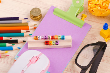 Business Campaign Concept background, colorful cube with word MARKETING PLAN on wooden desk