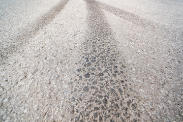 Fototapeta na wymiar Tire tracks on the road in perspective