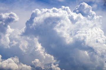Naklejka na ściany i meble Big cumulonimbus on blue sky. Cumulus, stratocumulus, stratus, altocumulus, nimbostratus. Dramatic sky with stormy clouds