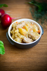 stewed potatoes with vegetables, cabbage and meat in a bowl
