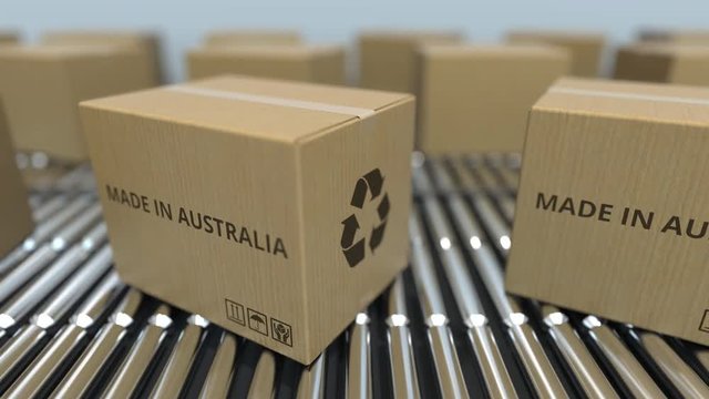 Cartons with MADE IN AUSTRALIA text on roller conveyor. Australian goods related loopable 3D animation